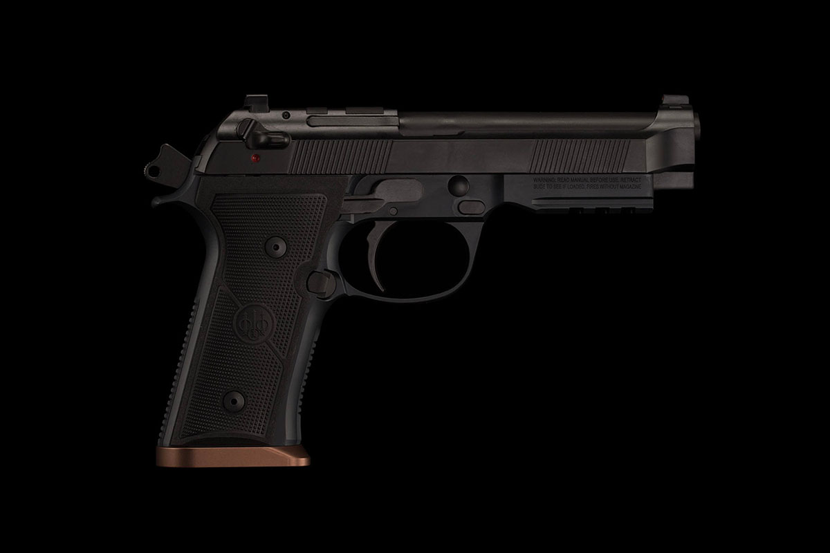 A Beretta pistol with an extended magazine well